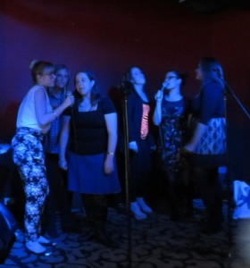 Sarah Kennet and Lauren  Kirkland to the left singing 'Oops!… I Did It Again'