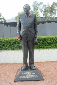A statue of Sir Edward "Weary" Dunlop, holding poppies.