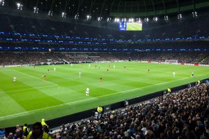 A game of Champions League football being played in a full stadium