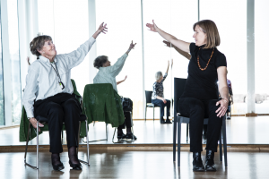 Two people enjoying an arm movement that forms part of the dance for wellbeing class