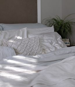 bed with white sheets and white pillows